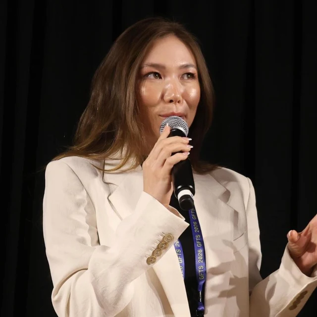 Brianna Honkawa d'Estries speaking on stage